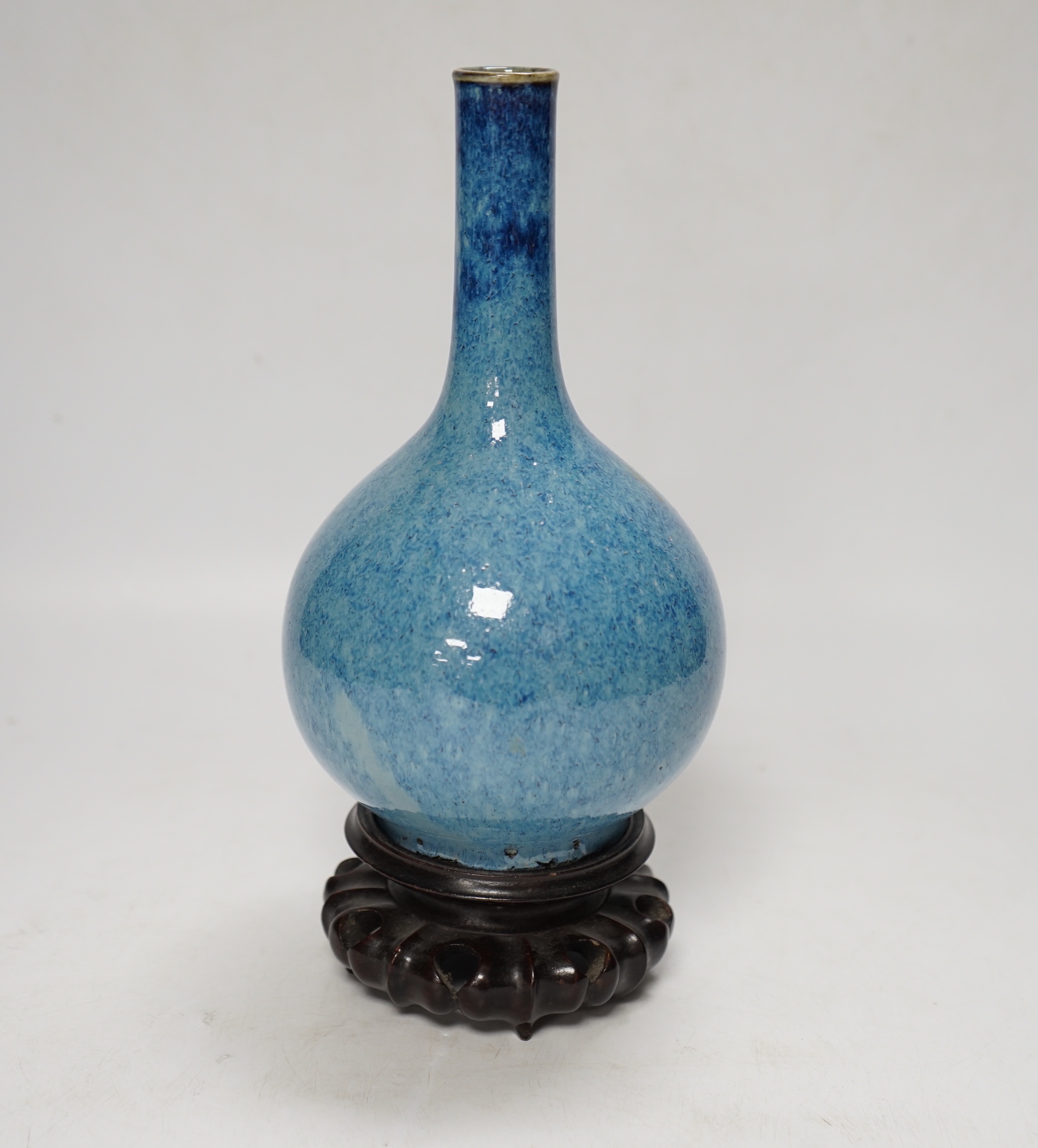 A Chinese blue flambe bottle vase, on stand, 22cm